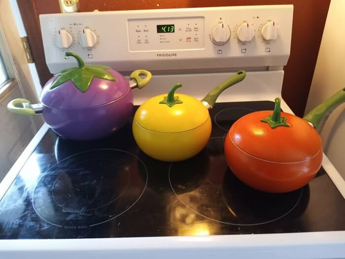 Colorful vegetable-shaped cookware set on a stove, showcasing unique second-hand discoveries.