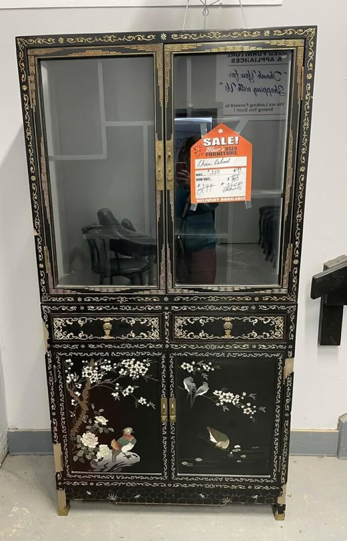 Second-hand black china cabinet with intricate floral and bird designs on sale.