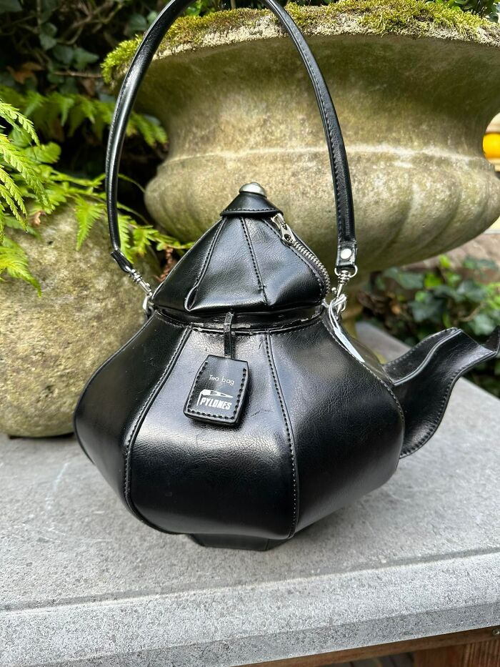 Unique second-hand teapot-shaped handbag in black leather, showcasing an eccentric and spectacular design.