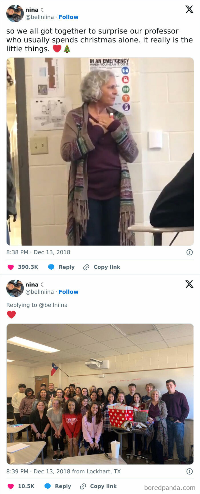 Group of students surprises professor with Christmas gifts in a classroom, sharing a wholesome moment.