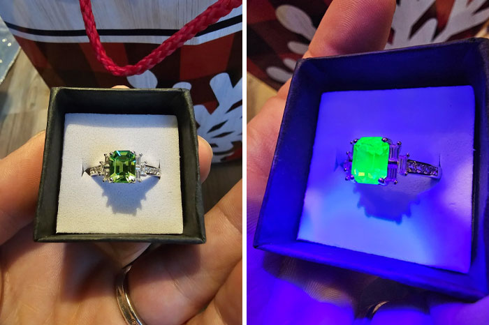 Engagement ring with glowing green gem in a box, creating a wholesome Christmas vibe.