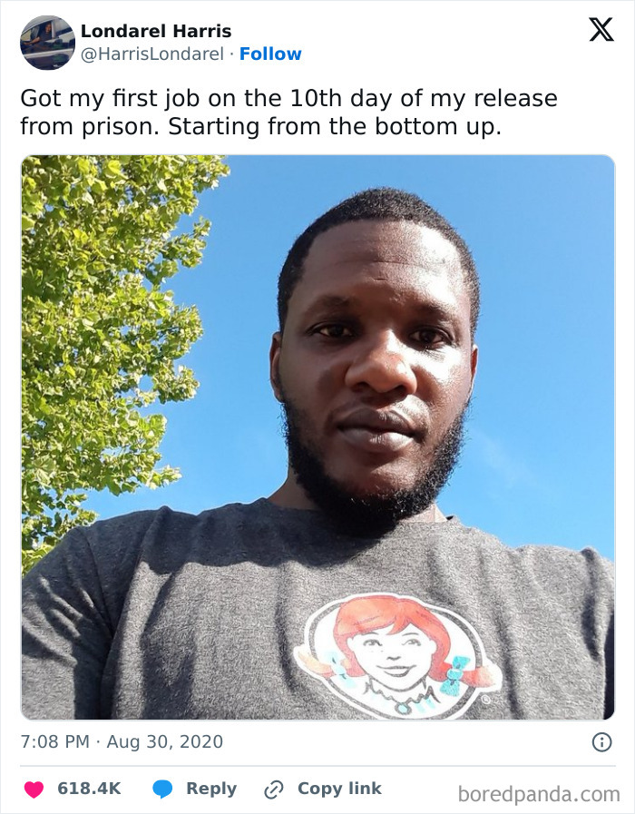 Man in Wendy’s shirt outdoors, smiling, achieving a milestone. Wholesome message about starting fresh brings positivity.