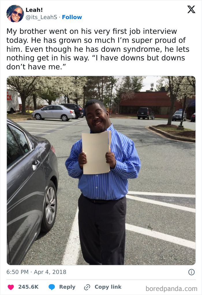 Man smiling after job interview, holding folder, embodies wholesome positivity.