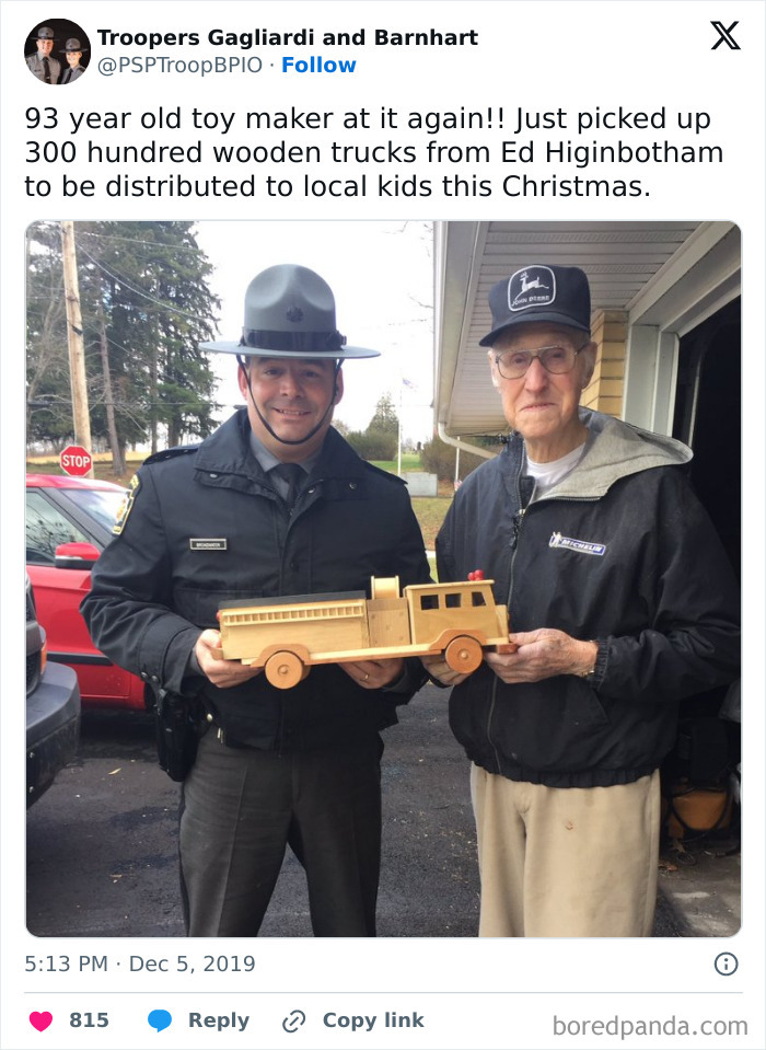 Officer and elderly man holding a handmade wooden truck, spreading happiness with wholesome crafts.