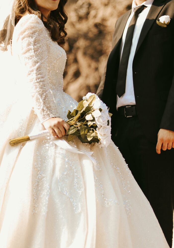 Bride and groom at a wedding, the bride holding a bouquet, illustrating a "You Up?" text escalating unexpectedly.