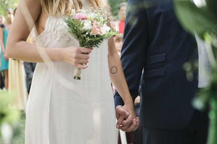 Bride and groom holding hands at a wedding ceremony, focusing on unexpected outcomes of messages.