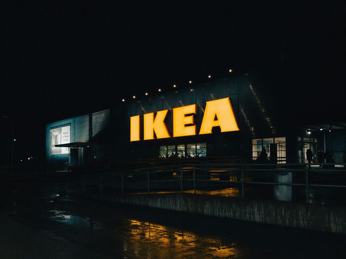 IKEA store at night with illuminated sign, showcasing unexpected late-night trip location.