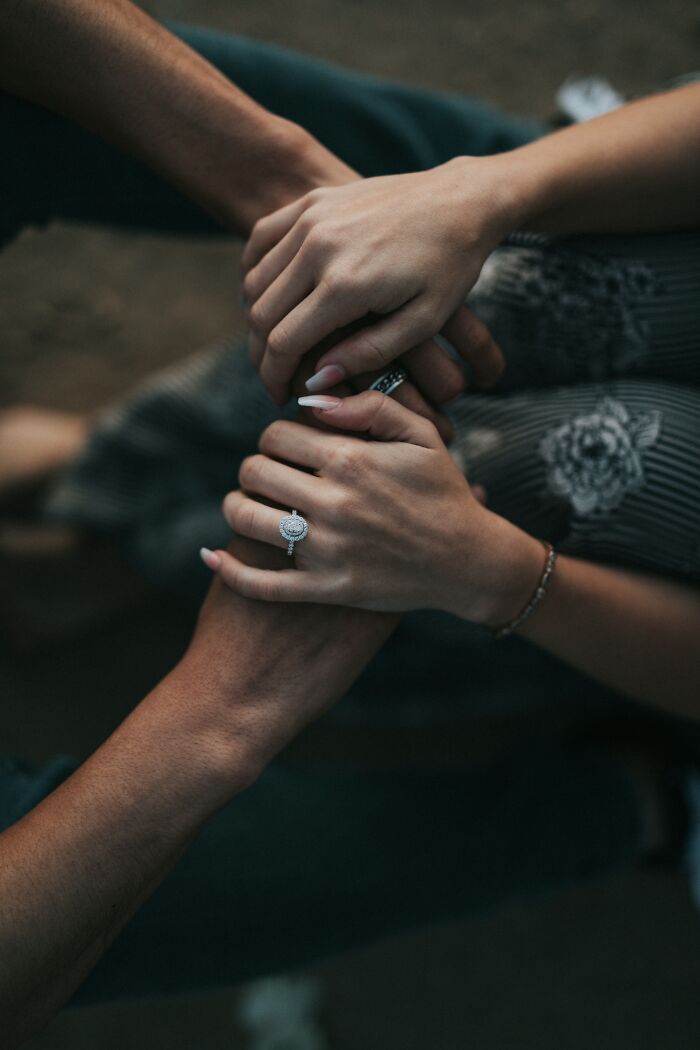 Couple holding hands, suggesting unexpected escalation after a "You Up?" text, with an engagement ring visible.