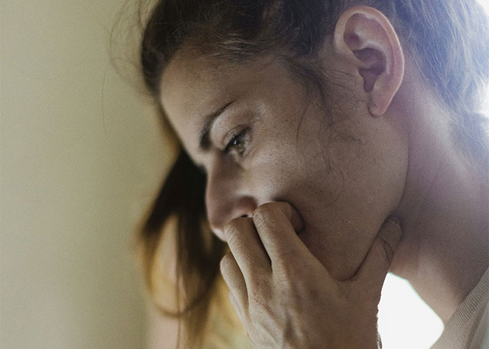 Woman looking concerned, highlighting relationship boundaries and family tensions.