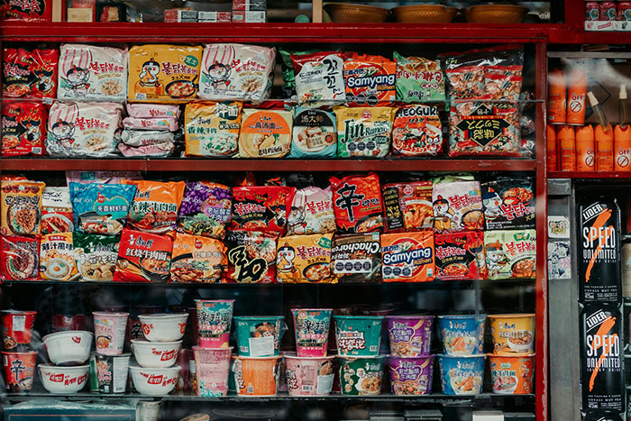 Variety of ramen packages displayed in a store, related to holiday gift-giving alternative.