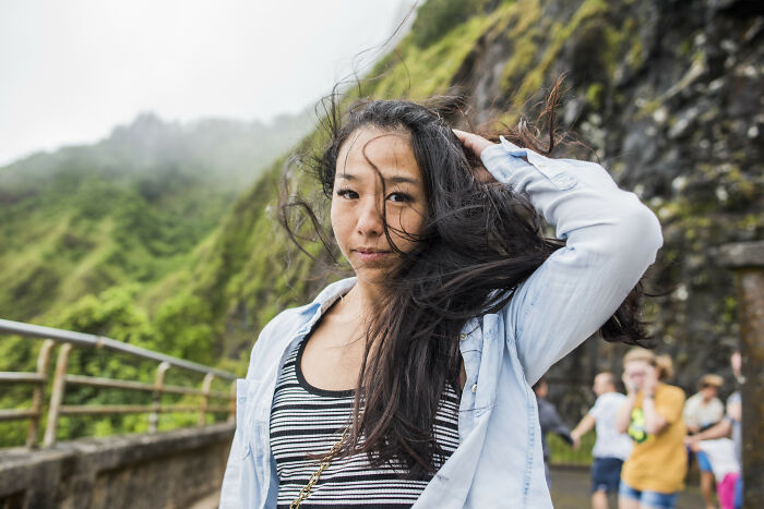 Woman on a windy mountain path, experiencing an astonishing coincidence.