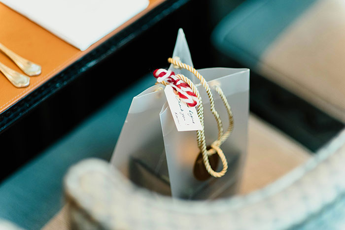 Gift bag with candy cane tag, representing Christmas presents that ruined the holiday spirit.