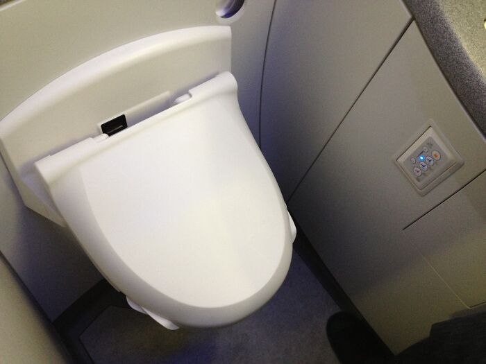 Airplane lavatory showing a cramped space, illustrating worst experience on long flight.