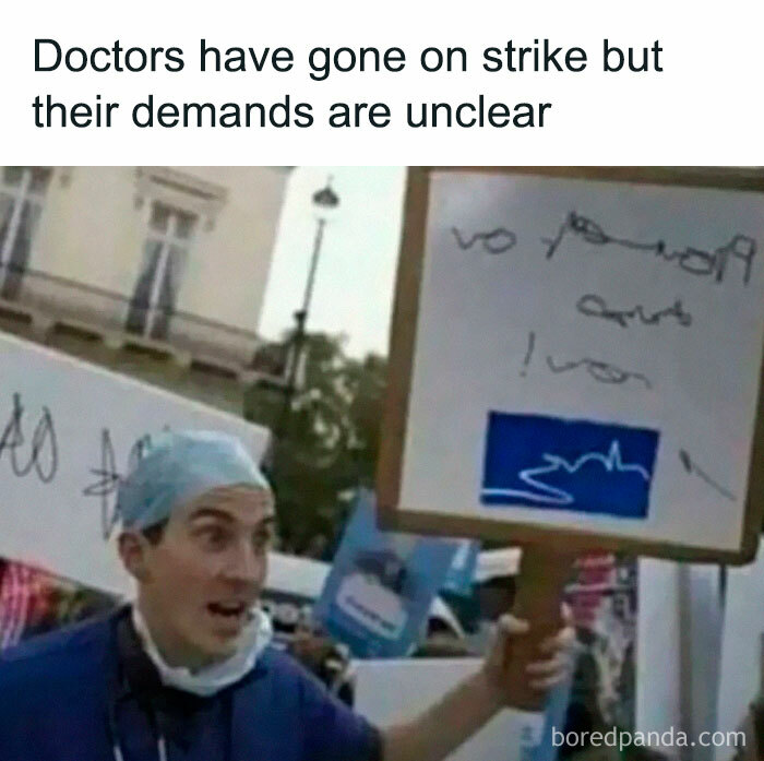 Doctor holding an unclear protest sign, part of a funny fail moment during a strike.