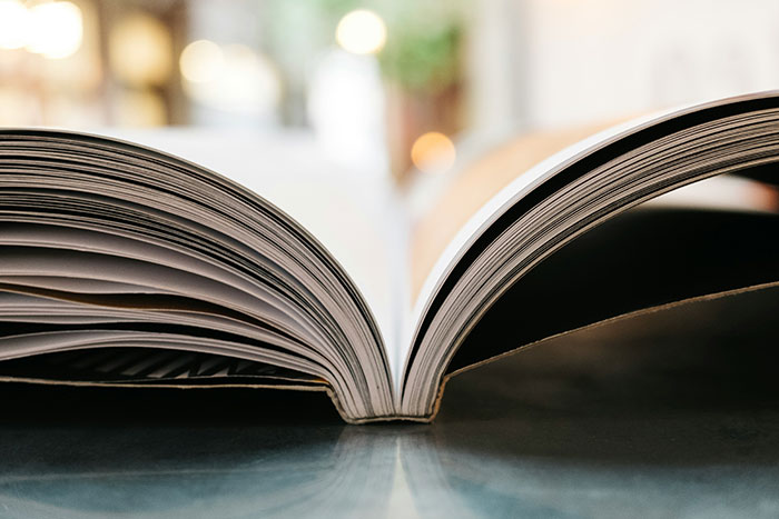 An open book on a table, symbolizing luck changes in secret Santa experiences.