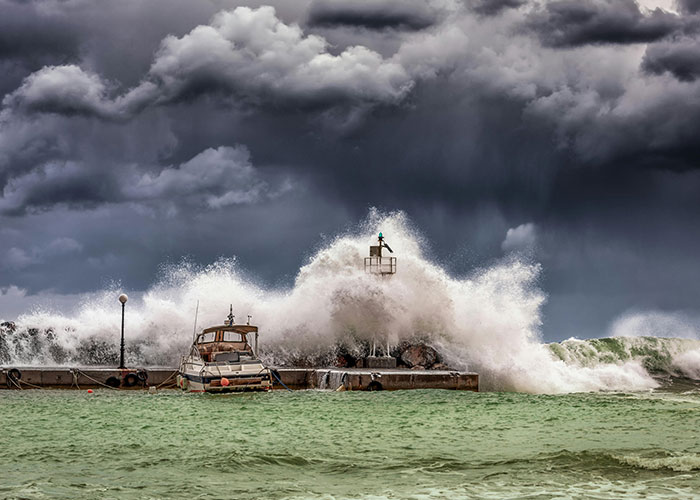 Stormy weather with waves crashing over a pier during Christmas.