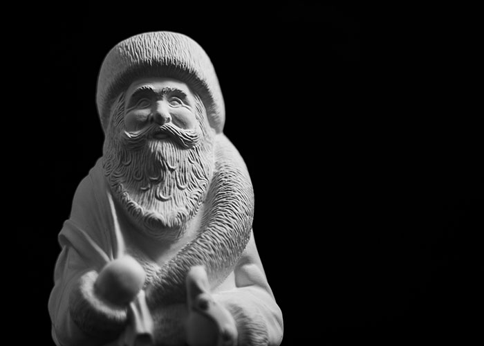 "Monochrome statue of Santa Claus symbolizing unfortunate Christmas events."