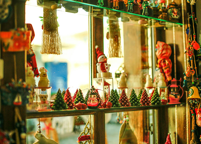 Christmas shop window displaying holiday ornaments and festive decorations.