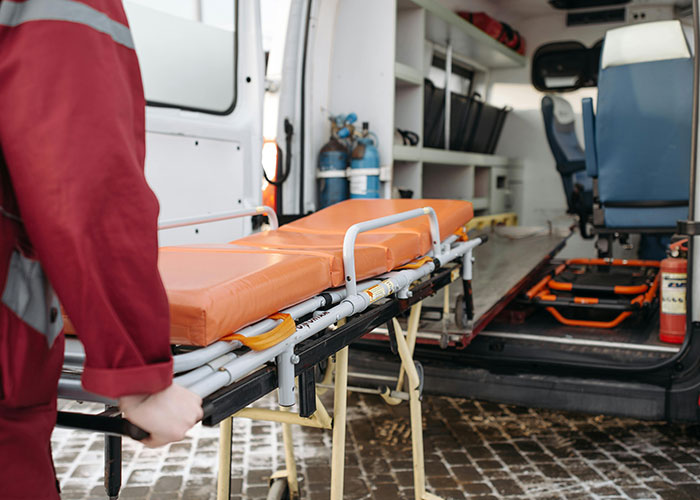 Ambulance stretcher being loaded, representing emergencies during Christmas.