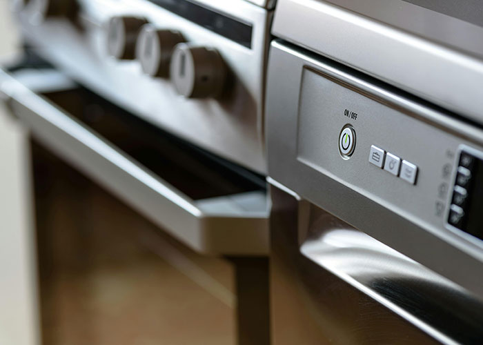 Close-up of a modern kitchen stove with knobs, representing worst things that happened at Christmas.