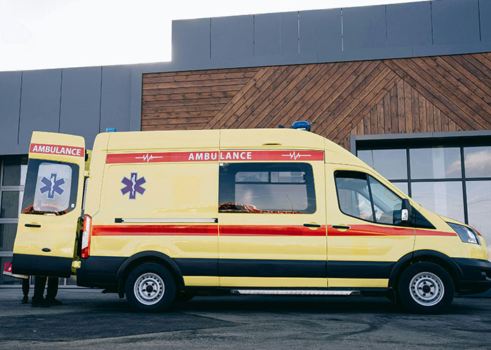 Yellow ambulance parked outside a building, related to worst things that happened at Christmas.