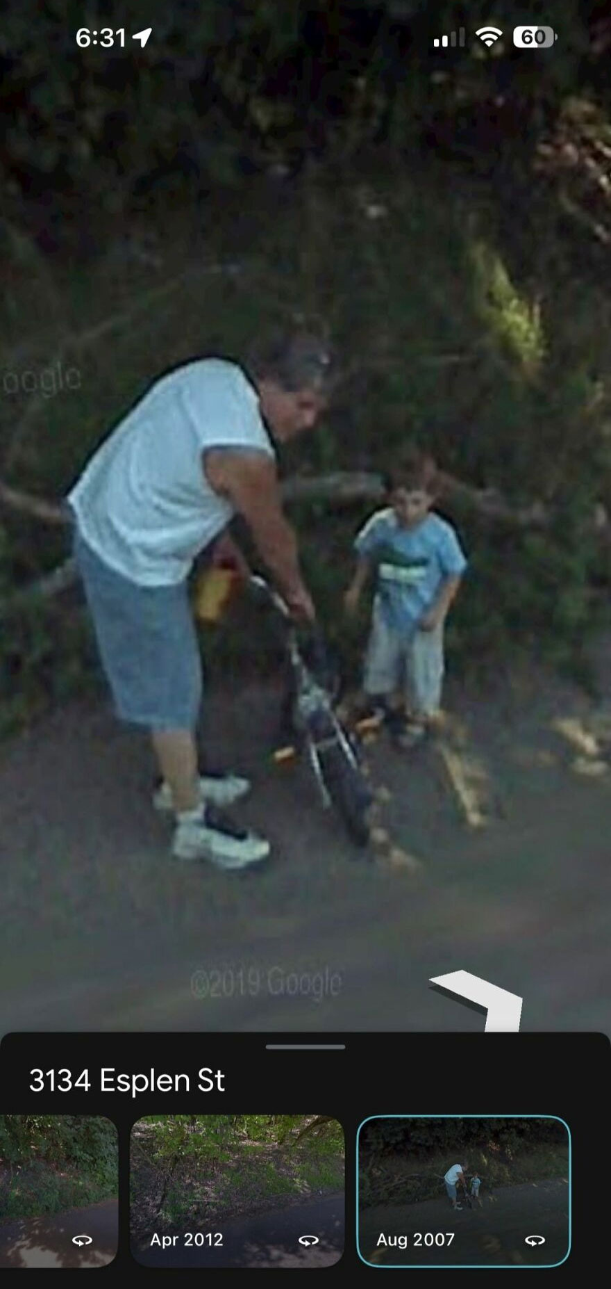 "Strange find on Google Earth: man helping child with bike on a shady street, captured in Aug 2007 at 3134 Esplen St."