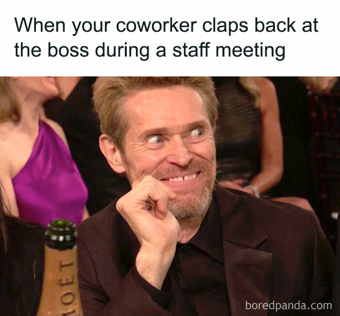 Man smirking at an event, with a caption about a coworker clapping back at the boss; office work meme humor.