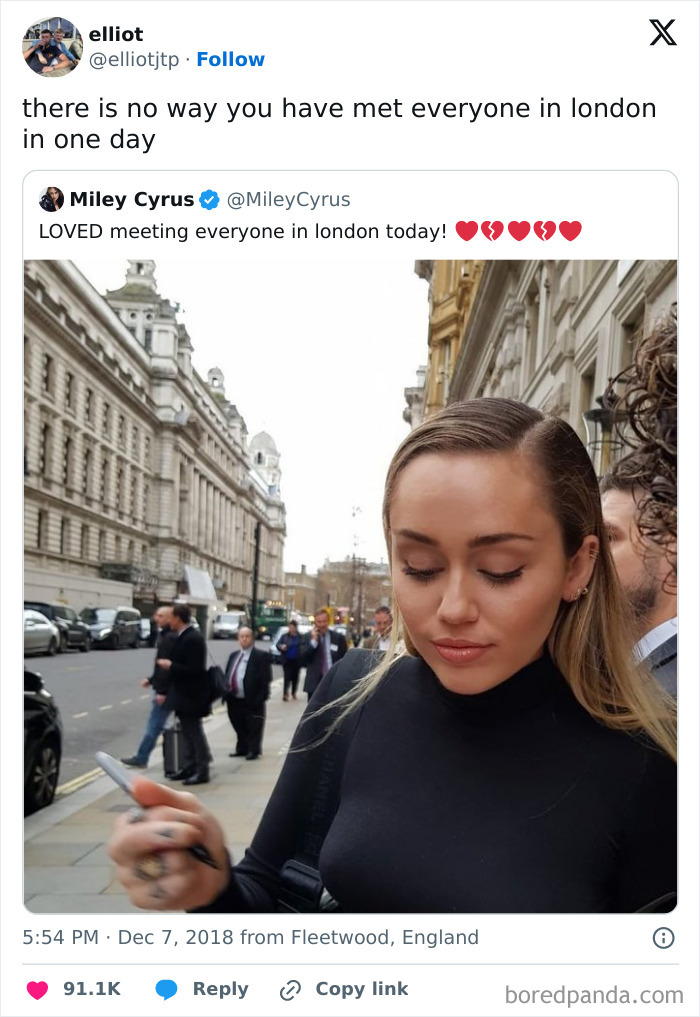 Person walking in a busy London street, signing an autograph, highlighted in a tweet about meeting people in London.