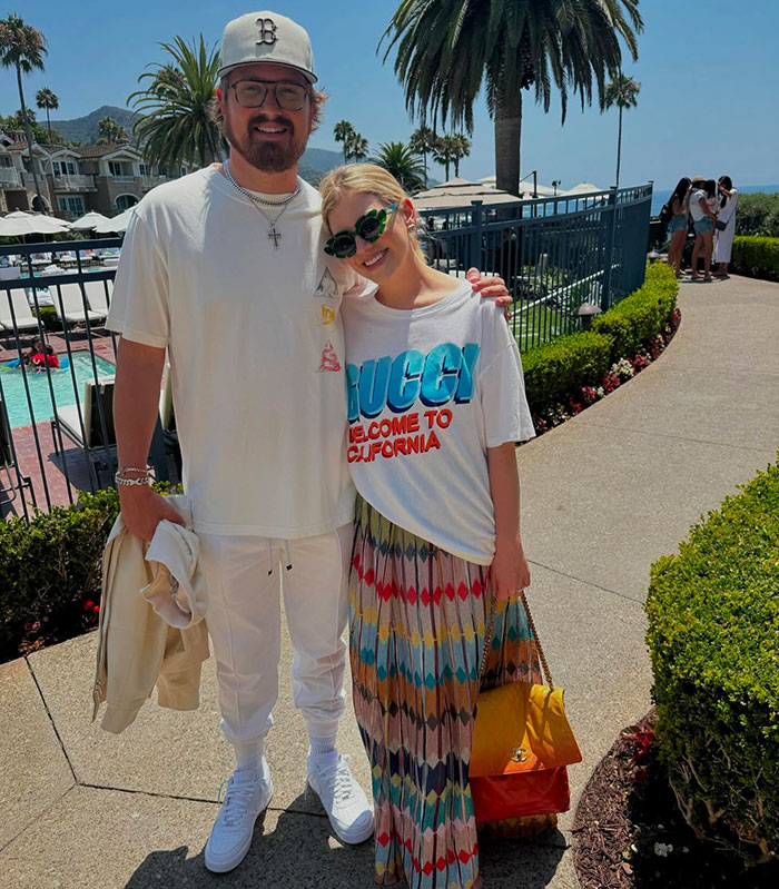 Couple smiling outdoors, connected to $59 million wedding news.