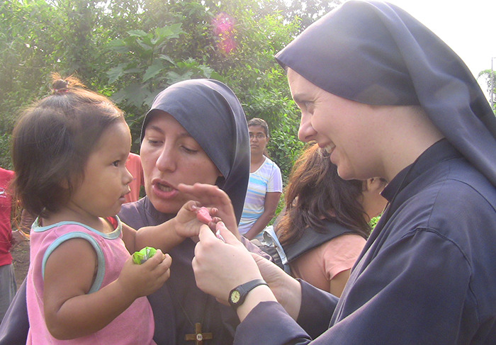 Nuns interacting with a child outdoors, related to "Wild Child" actress turned nun.