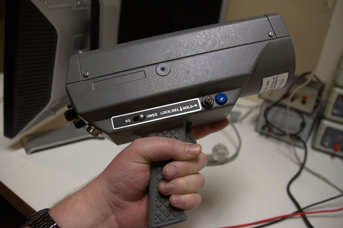 Hand holding a piece of contraband evidence related to police corruption.