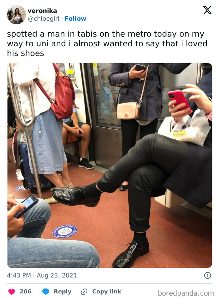 Funny train passenger wearing unique shoes and using a phone on a subway.