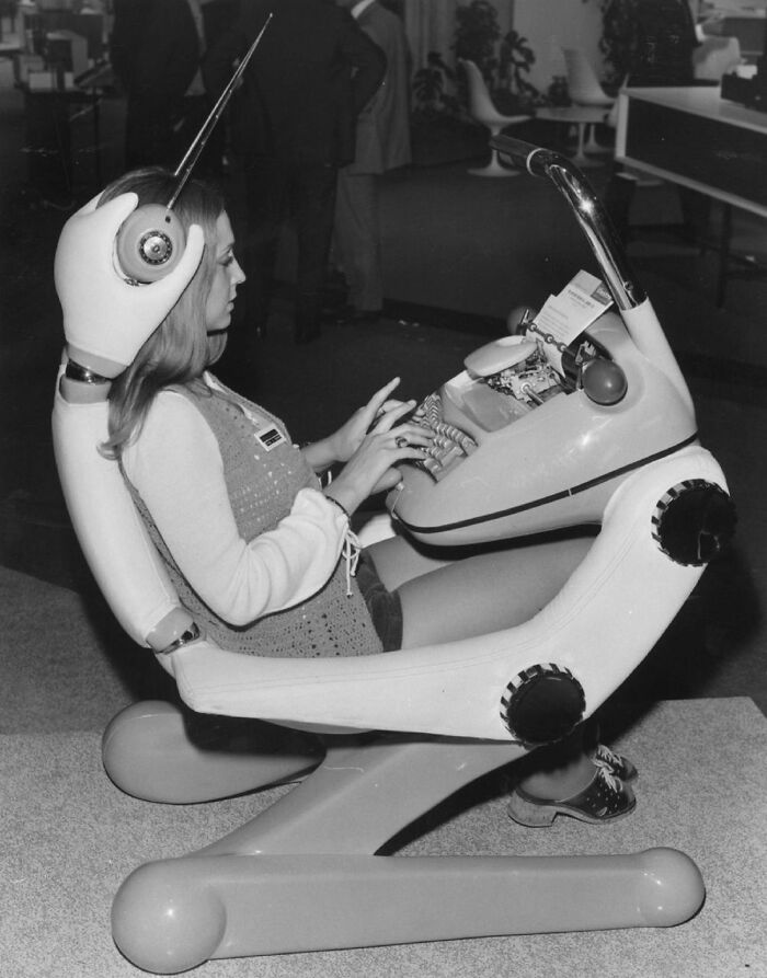 Woman operating a futuristic typing machine, an example of historical inventions ahead of their time.