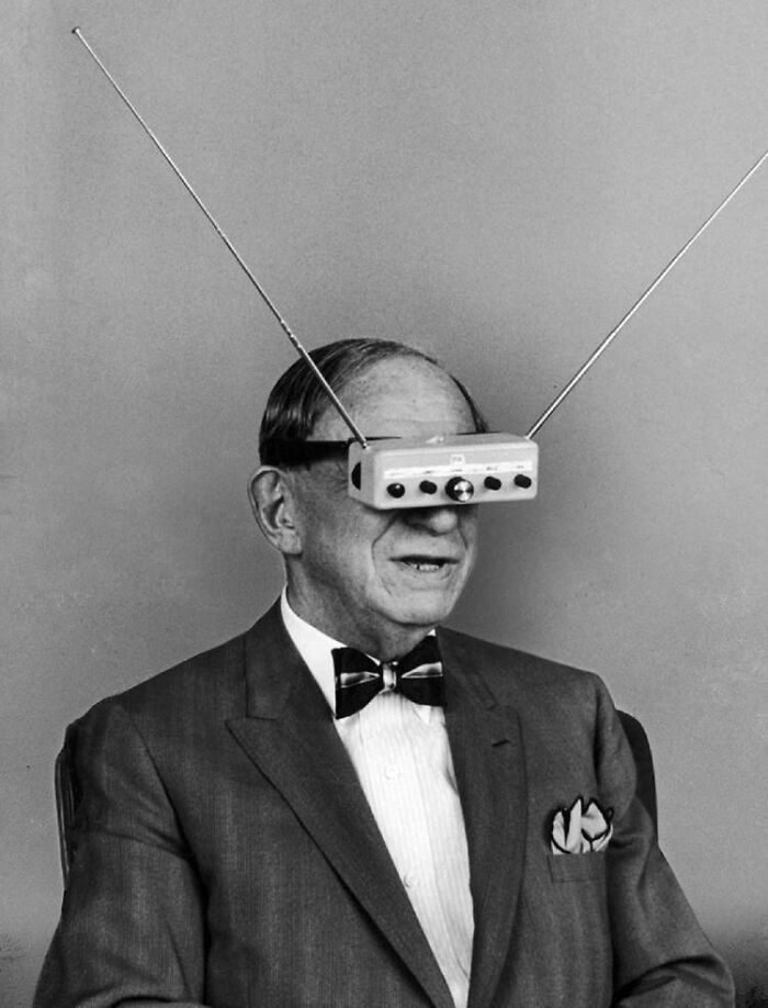 Man wearing an early television glasses invention, showcasing a historical innovation ahead of its time.