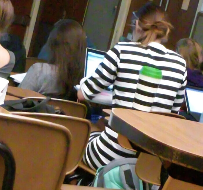 Confusing perspective in a classroom: stripes align with the chair, creating an optical illusion of a missing back.