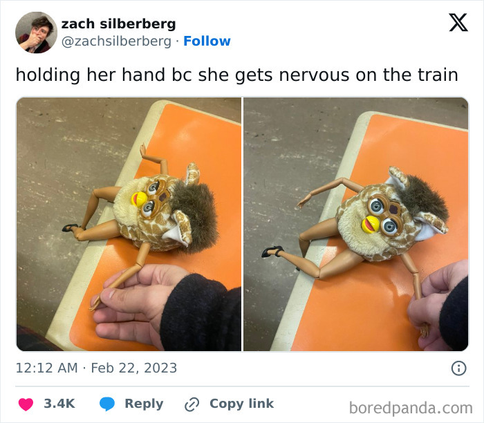 Person holding a toy on a subway seat, making it appear as a funny train passenger.