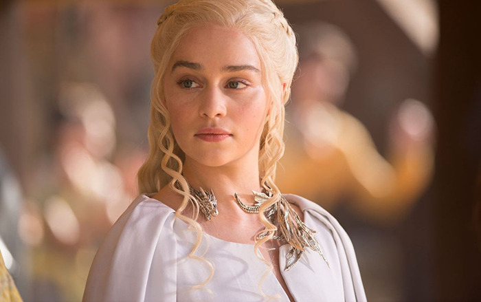 Khaleesi from Game of Thrones in a regal setting with braided hair and elegant attire.