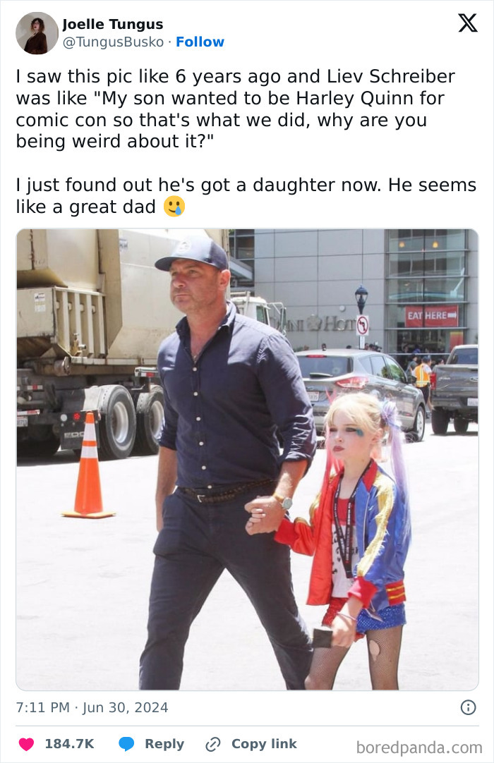 Father and child enjoy a comic-con event, capturing heartwarming kindness.