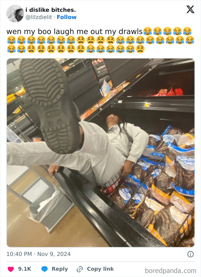 Person lying in a grocery display, feet up, amidst packed goods, embodying "people being complete jerks" theme.