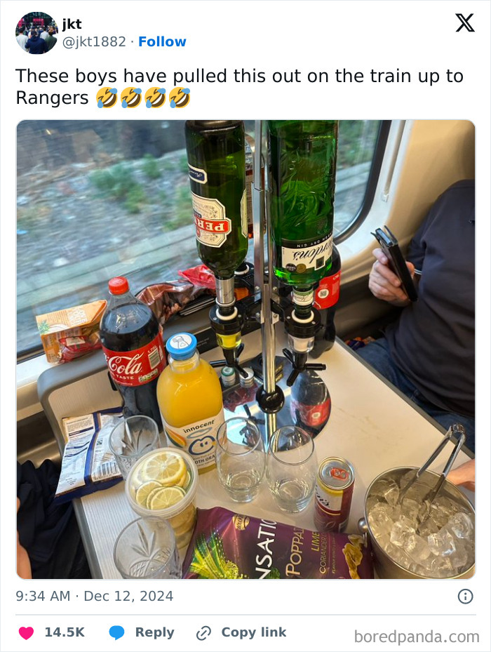 Impromptu bar setup by passengers on a train journey, featuring drinks and snacks.