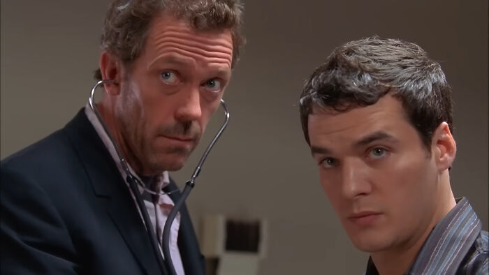 Two men in a dramatic scene from a beloved show, one holding a stethoscope.