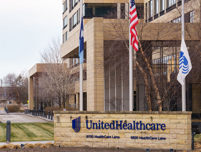 Exterior of UnitedHealthcare building with flags, related to doctor criticizing insurance.