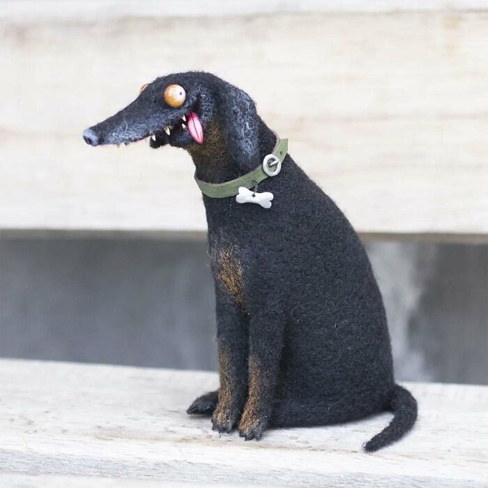 Strange art doll depicting a quirky, funny-looking animal with large eyes and a green collar, created by a Georgian artist.