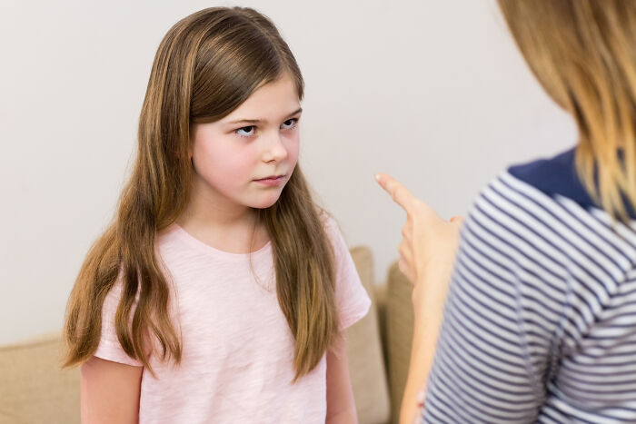 Child being scolded, showcasing signs of a horrible parenting moment.