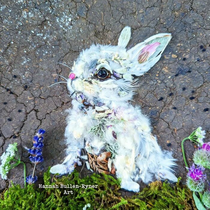 A detailed rabbit portrait crafted from natural materials on cracked earth, highlighting earth art and nature creativity.