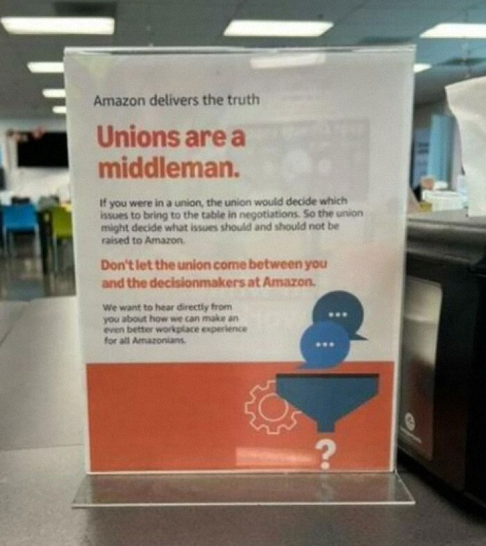 "Sign in an office reading 'Unions are a middleman' suggesting a boring dystopia theme."