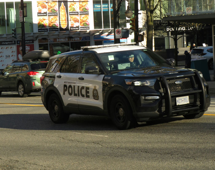 Police SUV on a city street, highlighting law enforcement activities.