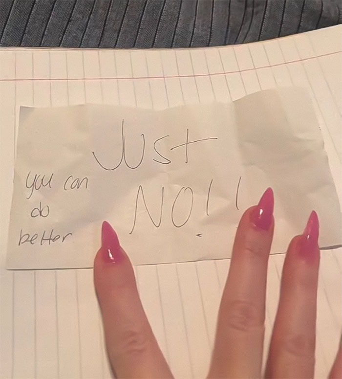 A woman's hand holding a note saying "Just NO!!" and "you can do better" on a lined notebook.