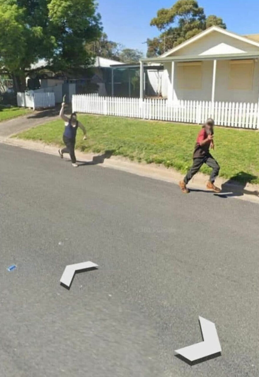 Two people running on a suburban street, captured on Google Earth.