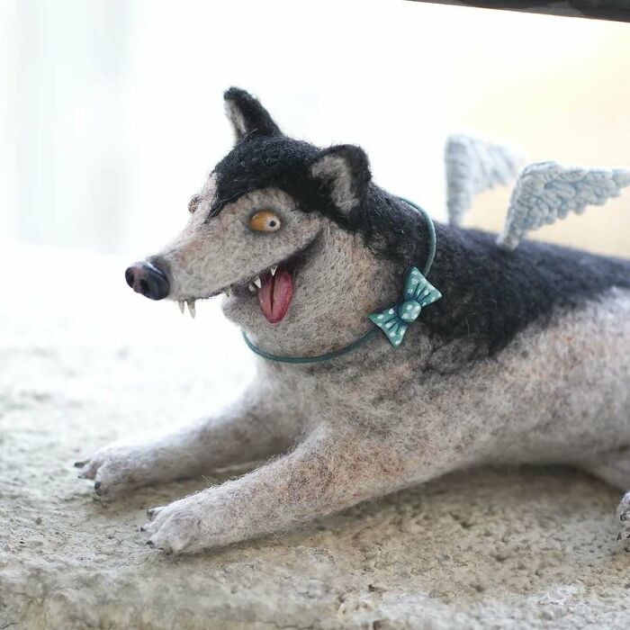 Strange art doll resembling a funny-looking animal with wings and a teal bow, crafted by a Georgian artist.